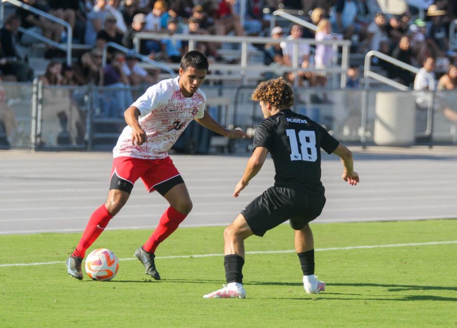 Senior midfielder Blake Bowen attempts to keep the ball away from the Oregon Beavers on Sunday, October 2, 2022. 