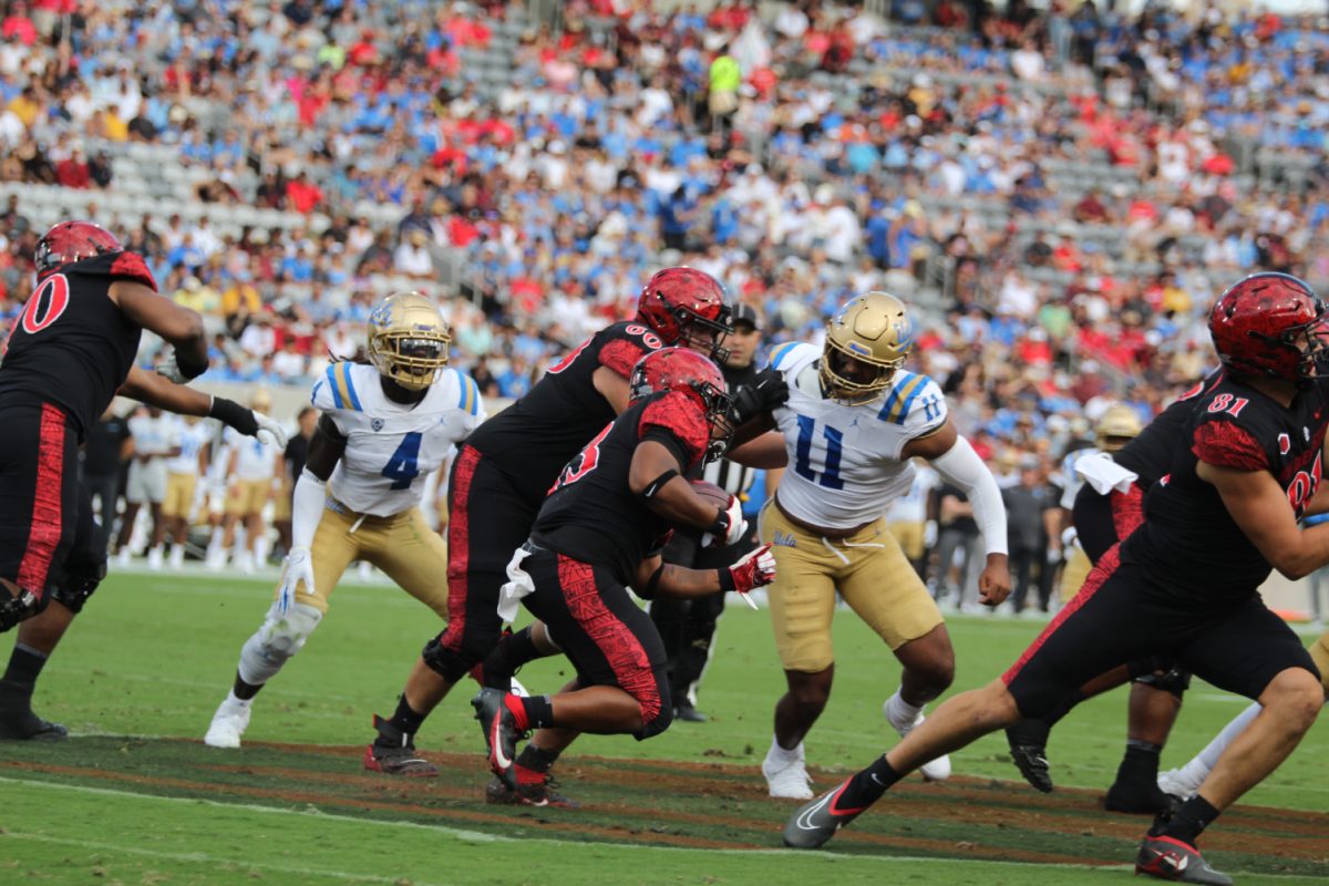 San Diego State running back Keenan Christon carries the ball earlier this season against UCLA at Snapdragon Stadium.