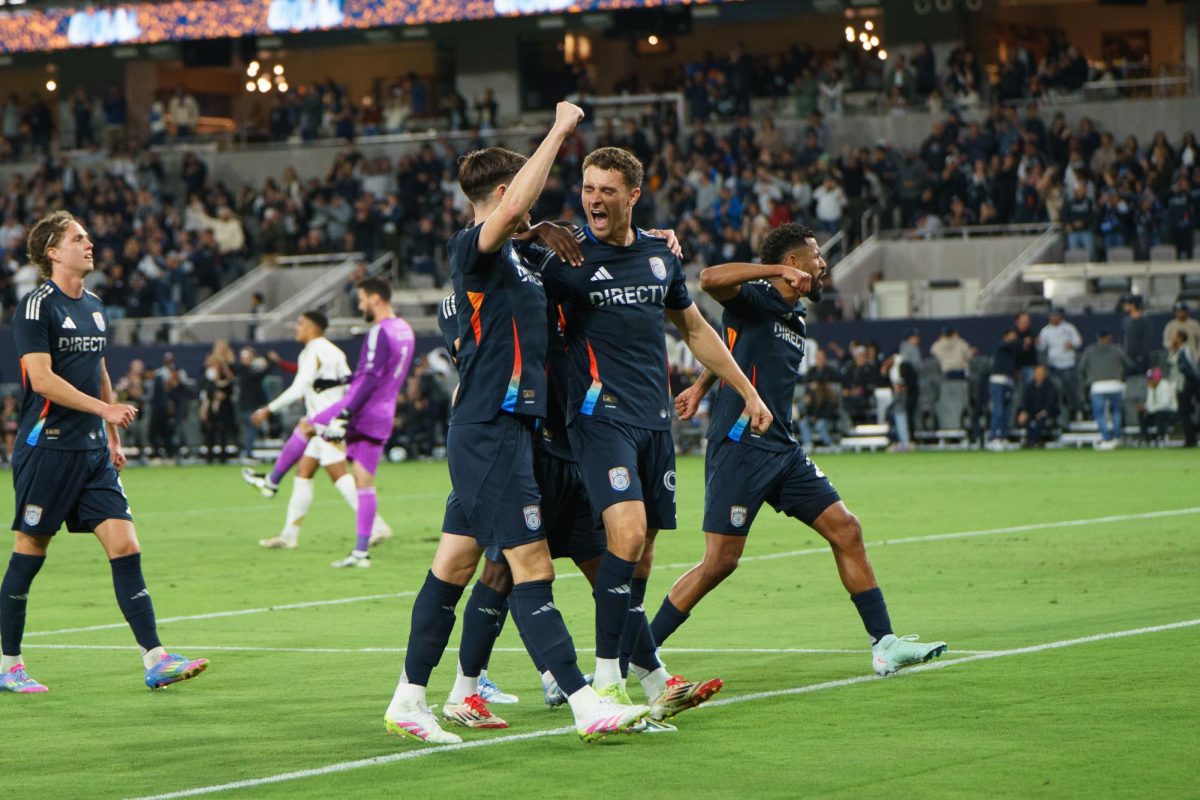 San Diego FC defender Christ McVey, middle, yells in celebration with defender Paddy McNair, left, after he scores the first goal of the game against Los Angeles FC at Snapdragon Stadium on March 29, 2025.