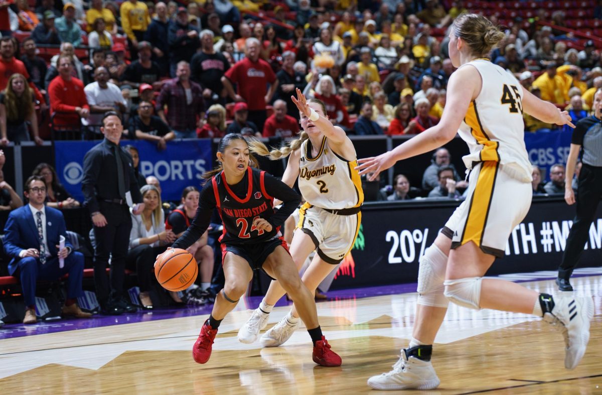 San Diego State guard Naomi Panganiban looks to pass between Wyoming players Emily Mellema (2) and Mikyn Hamlin (45) during the Mountain West Championship in Las Vegas at the Thomas & Mack Center on March 12, 2025. 