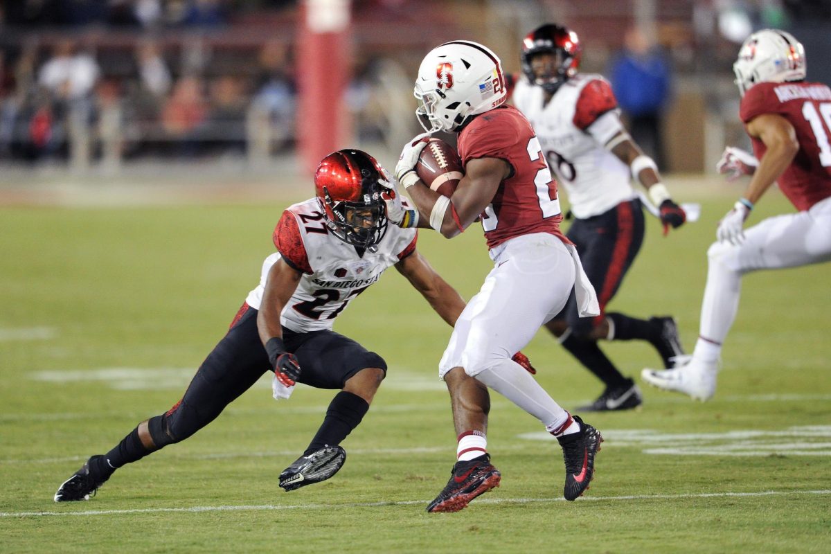 Former San Diego State safety Kyree Woods makes a tackle against a Stanford player during a football game. Image courtesy of San Diego State Athletics. (Ernie Anderson/SDSU Athletics)

