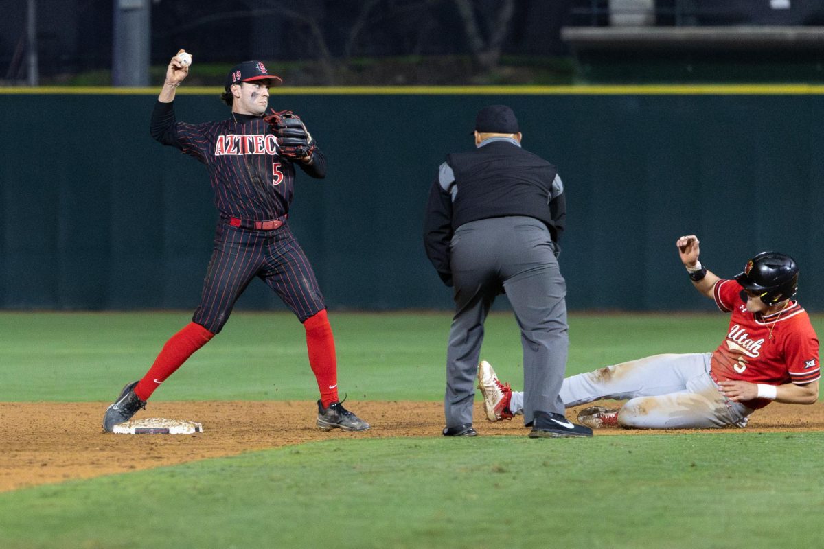San Diego State second baseman Nevan Noonan tries to throw out the batter at first base after getting the force out at second against Utah on Friday, Feb. 21, 2025, at the Tony Gwynn Stadium in San Diego, Calif. 